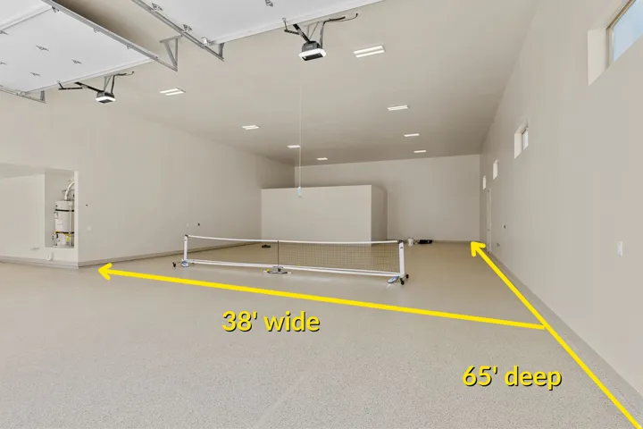 Expansive garage space with a light-colored, speckled epoxy floor