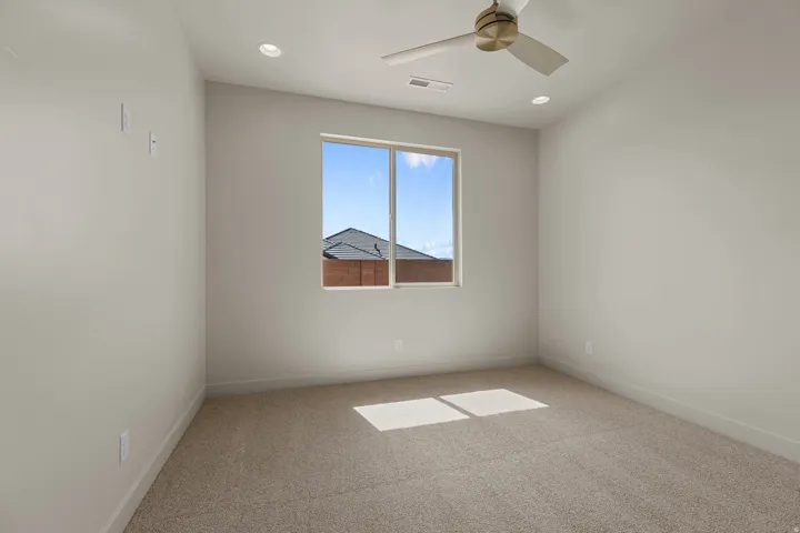Carpeted room featuring a single window, recessed lighting, and a ceiling fan