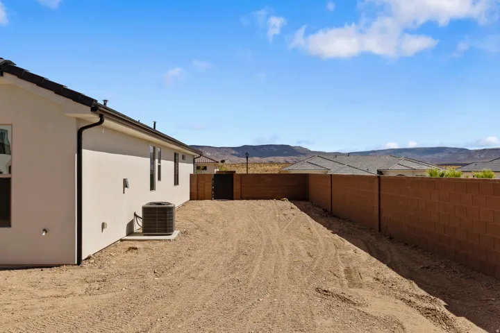 Expansive undeveloped yard space with a sturdy block wall perimeter