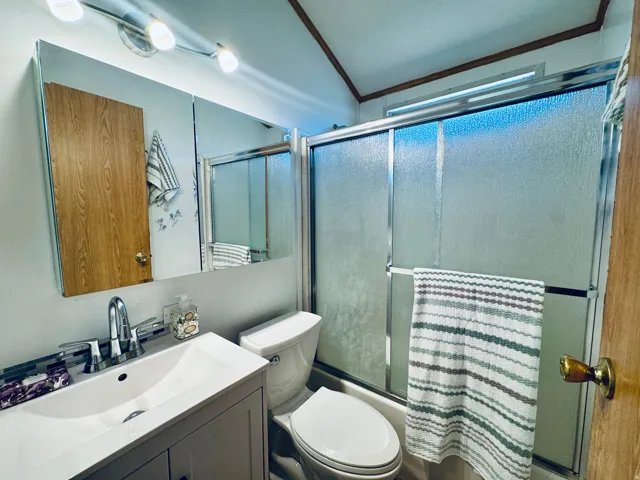 Bathroom featuring a white vanity with integrated sink, chrome faucet, and a wall-mounted mirrored medicine cabinet