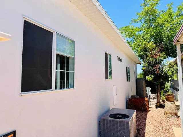 Exterior wall with multiple windows and white siding