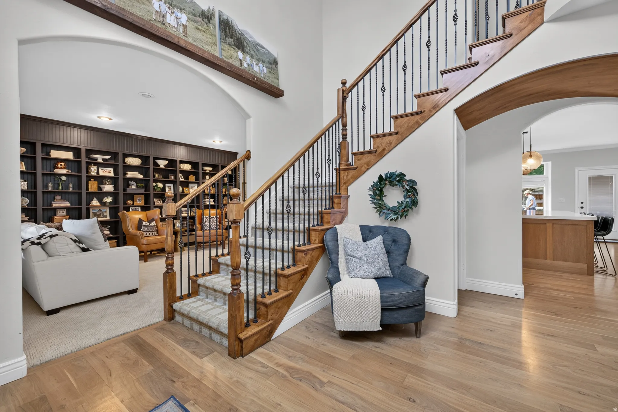 Grand staircase with wood-finish treads and wrought iron balusters