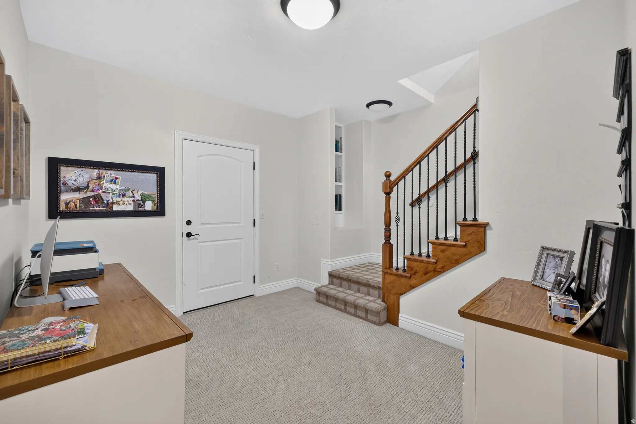 Architectural staircase featuring wood treads, a wood banister, and wrought iron balusters
