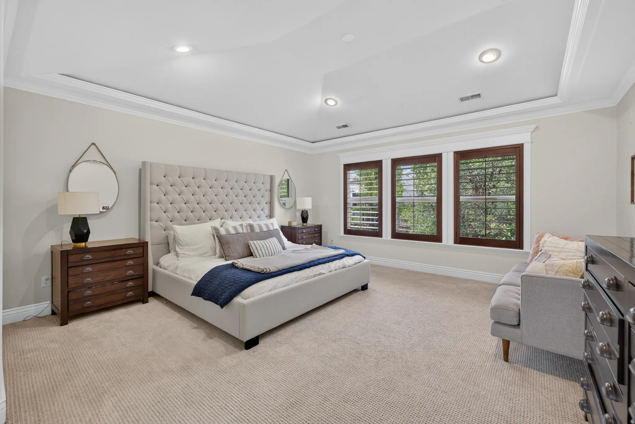 Spacious interior room featuring a tray ceiling with recessed lighting