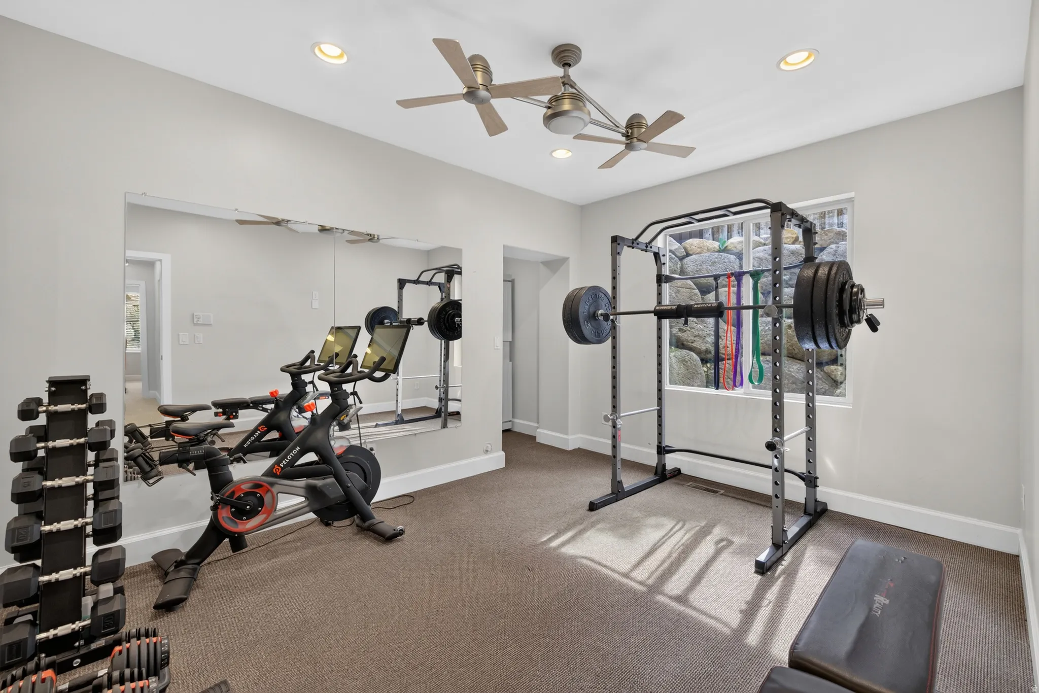 Dedicated fitness space featuring wall-to-wall carpeting, recessed lighting, and two ceiling fans