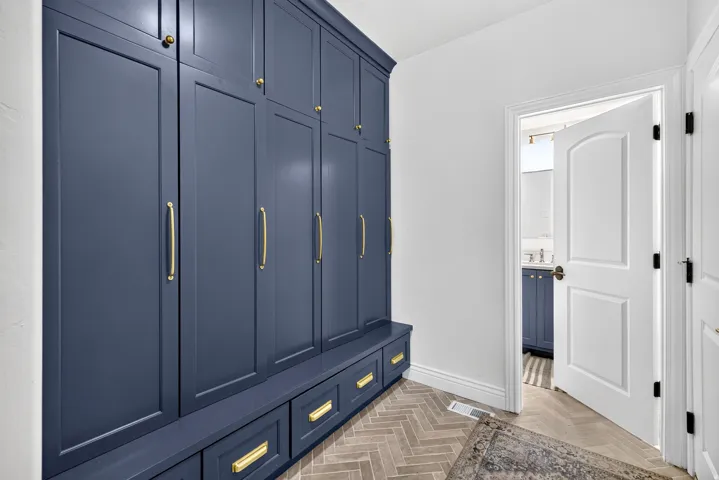 Built-in navy cabinetry with gold-tone hardware, providing extensive storage