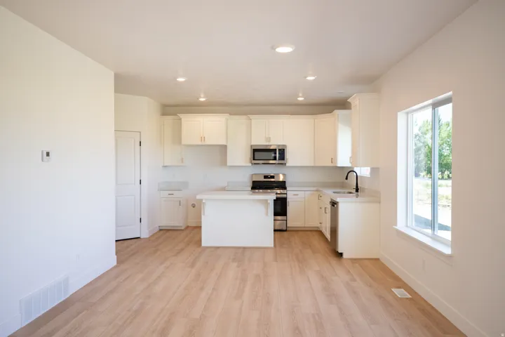 Kitchen with upgraded cabinets, quartz counters, and stainless steel appliances
