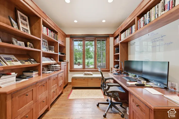 Custom built-in wood cabinetry, wood-finish flooring, recessed lighting, double-pane window, and integrated desk space