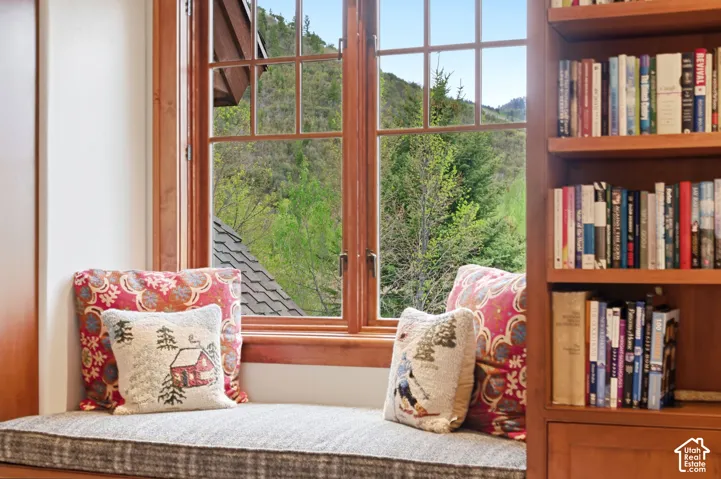 Custom built-in window seat with a multi-pane window, solid wood trim, and integrated wood cabinetry
