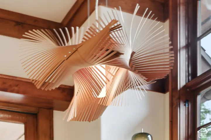 Designer pendant light fixture, wood-finish window trim, and wood-finish ceiling beams
