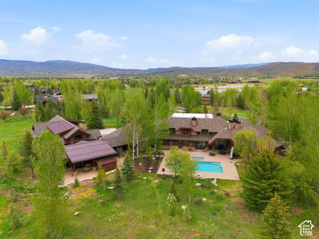 Expansive property featuring a multi-level residence, private swimming pool, and stone patio
