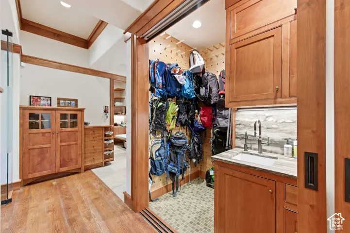 Wood-finish flooring with a built-in cabinetry and a utility sink