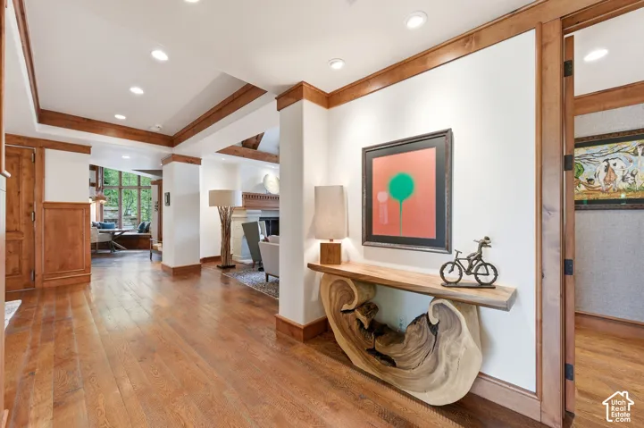 Recessed ceiling lighting, wood-finish flooring, wood trim, wood paneling, and an integrated window seat