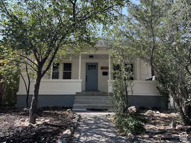 White exterior with a light blue entry door