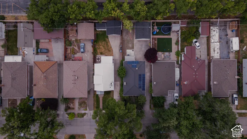 Aerial perspective showcasing multiple properties with varied rooflines and rear yard configurations