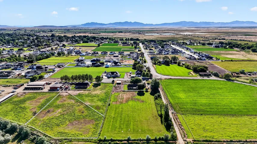 Expansive aerial showcasing a residential area interspersed with agricultural fields