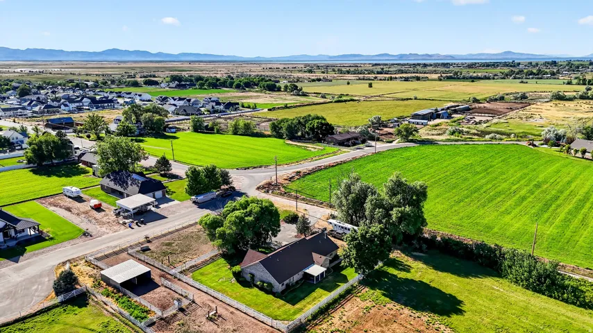 Aerial perspective showcasing expansive green fields and distant mountains