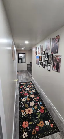 Hallway featuring wood-finish flooring, recessed lighting, and a neutral wall palette