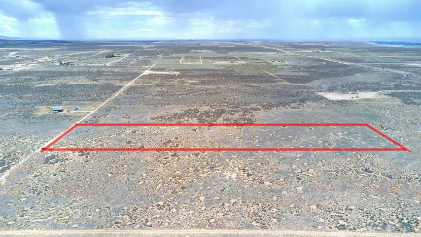 Expansive undeveloped land parcel outlined in red, featuring natural desert vegetation