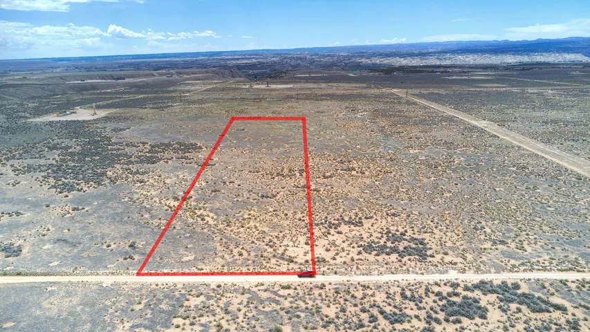 Expansive undeveloped desert land with a clear boundary marking