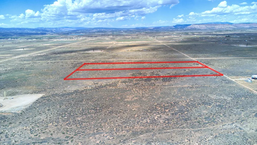 Expansive desert land featuring multiple parcels delineated by red outlines