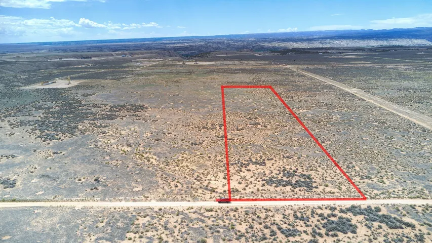 Expansive desert acreage featuring a defined property boundary