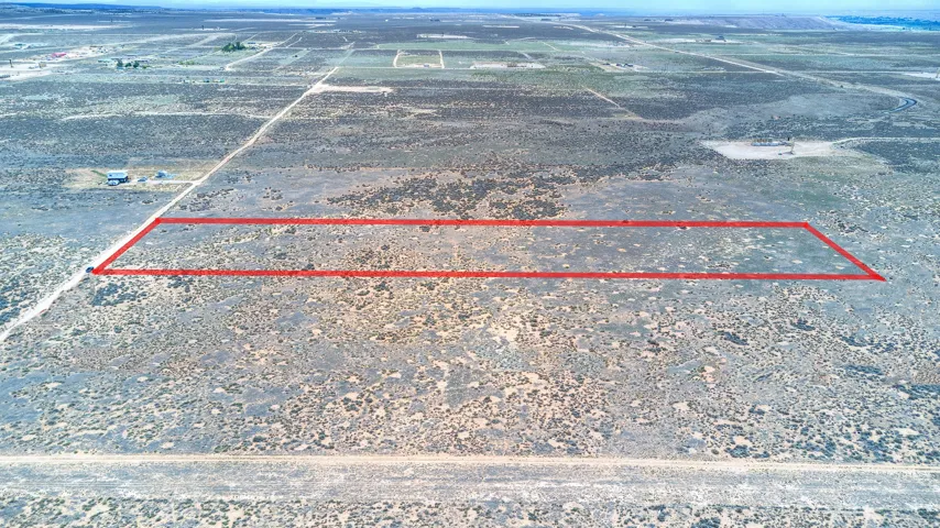 Expansive desert landscape featuring a clearly delineated rectangular parcel of land