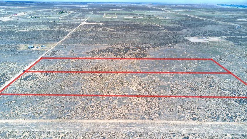 Expansive undeveloped lot featuring a natural desert landscape with defined property lines