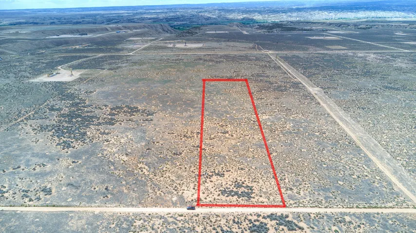 Expansive undeveloped land featuring a defined rectangular parcel, natural desert vegetation, and surrounding open terrain