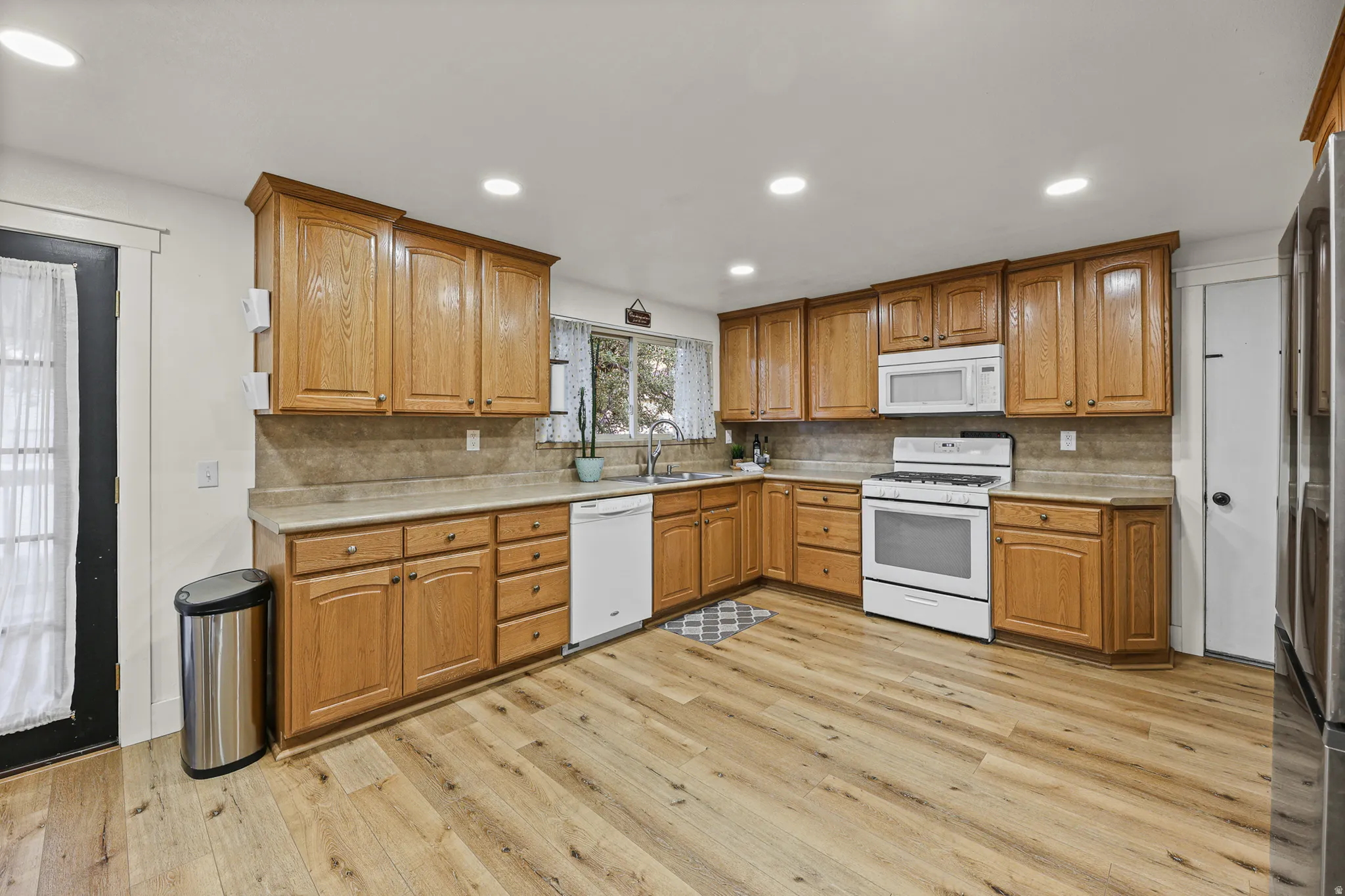 Kitchen featuring wood-finish flooring and recessed lighting