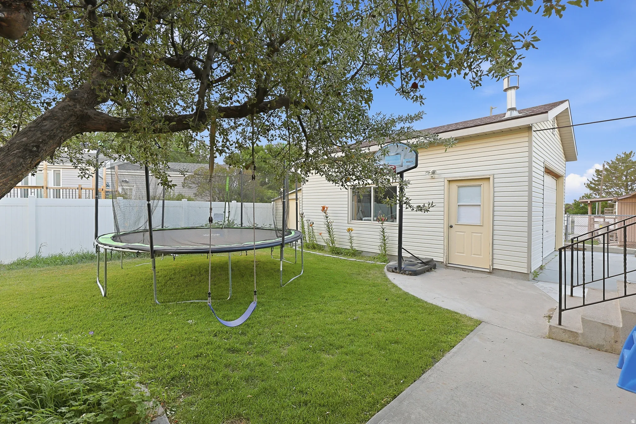View of yard and detached garage with wood burning stove