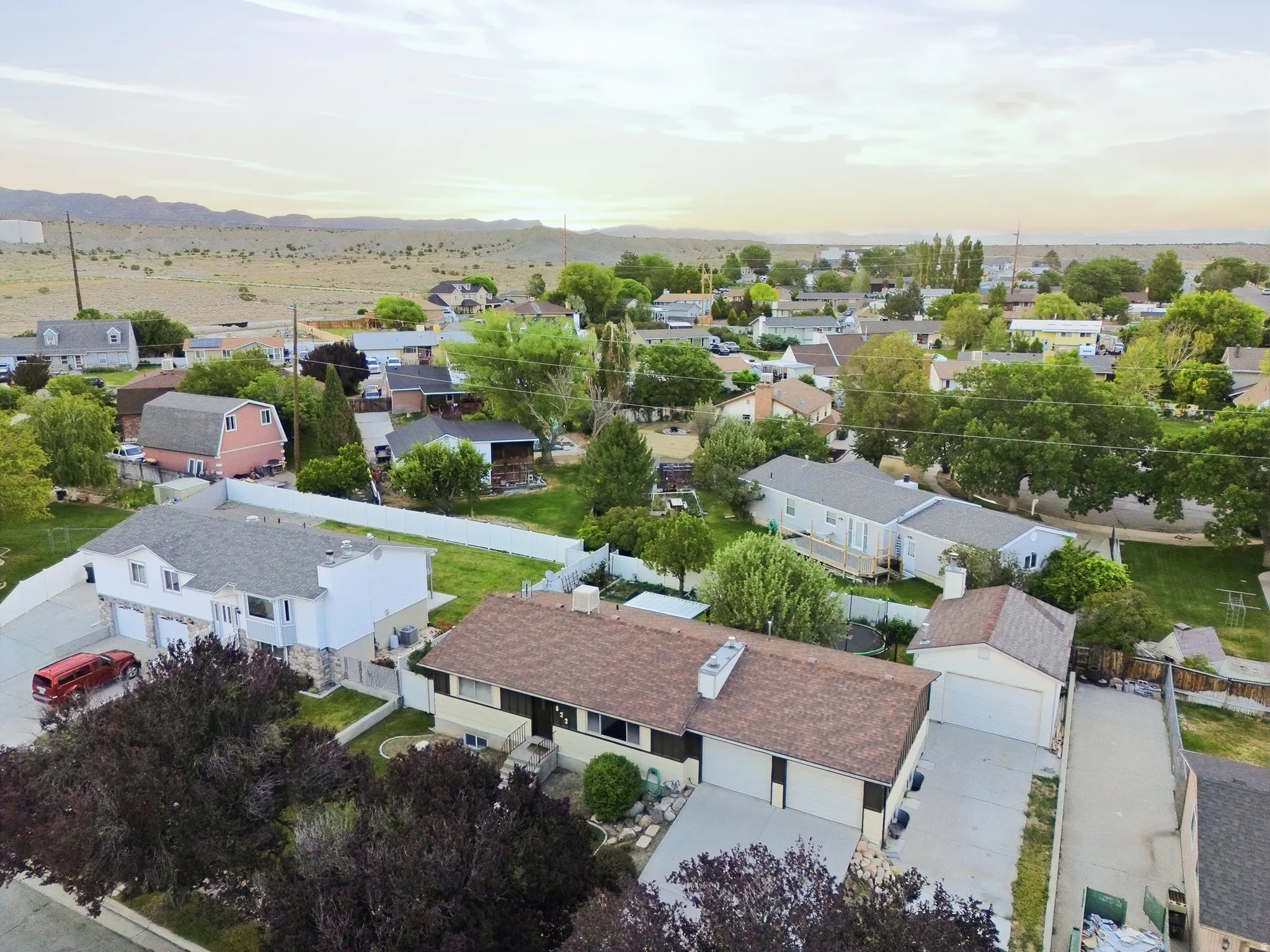 Aerial perspective showcasing a residential area with mature trees and suburban homes