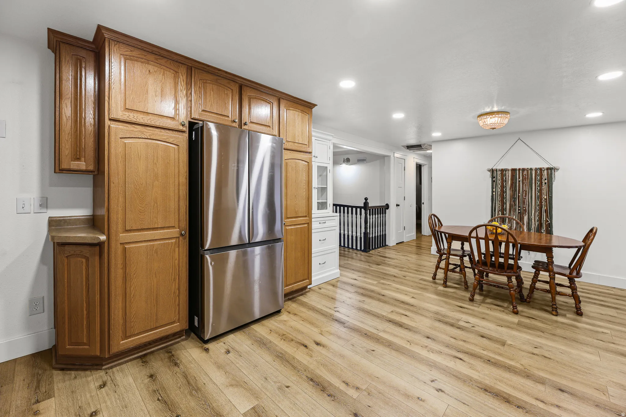 Expansive kitchen and dining area featuring wood-finish flooring