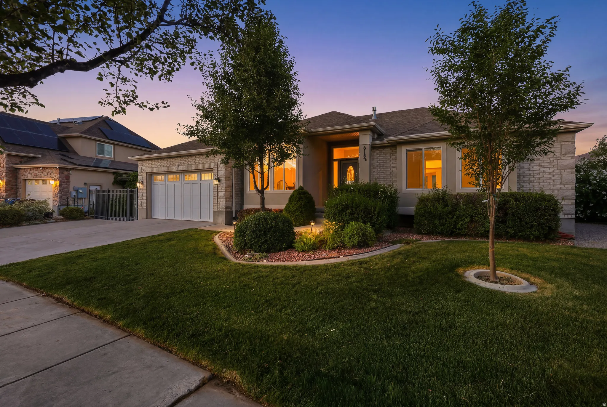 Stone and stucco exterior with an attached two-car garage