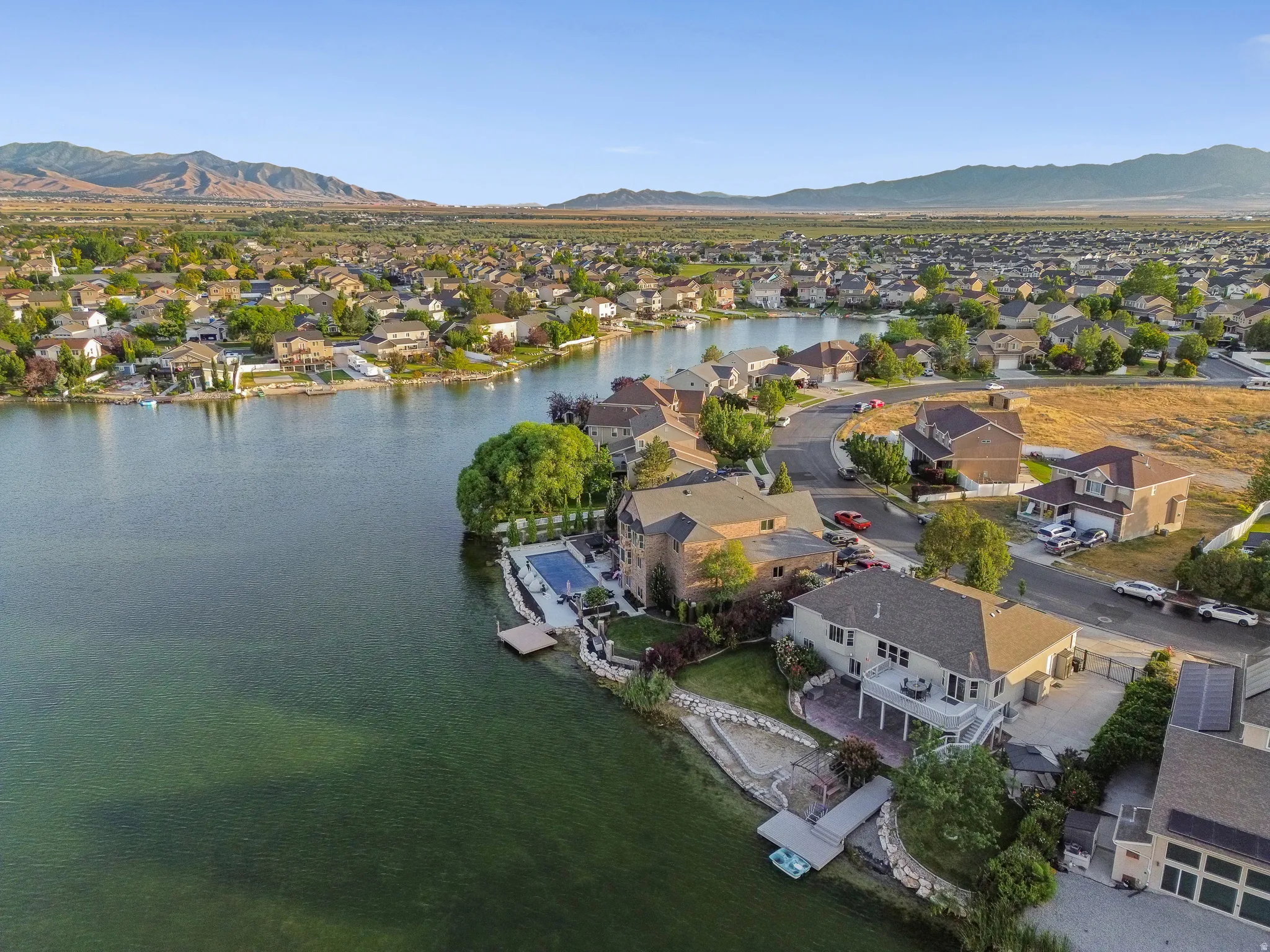 Aerial perspective of a lakeside community featuring homes with various architectural styles