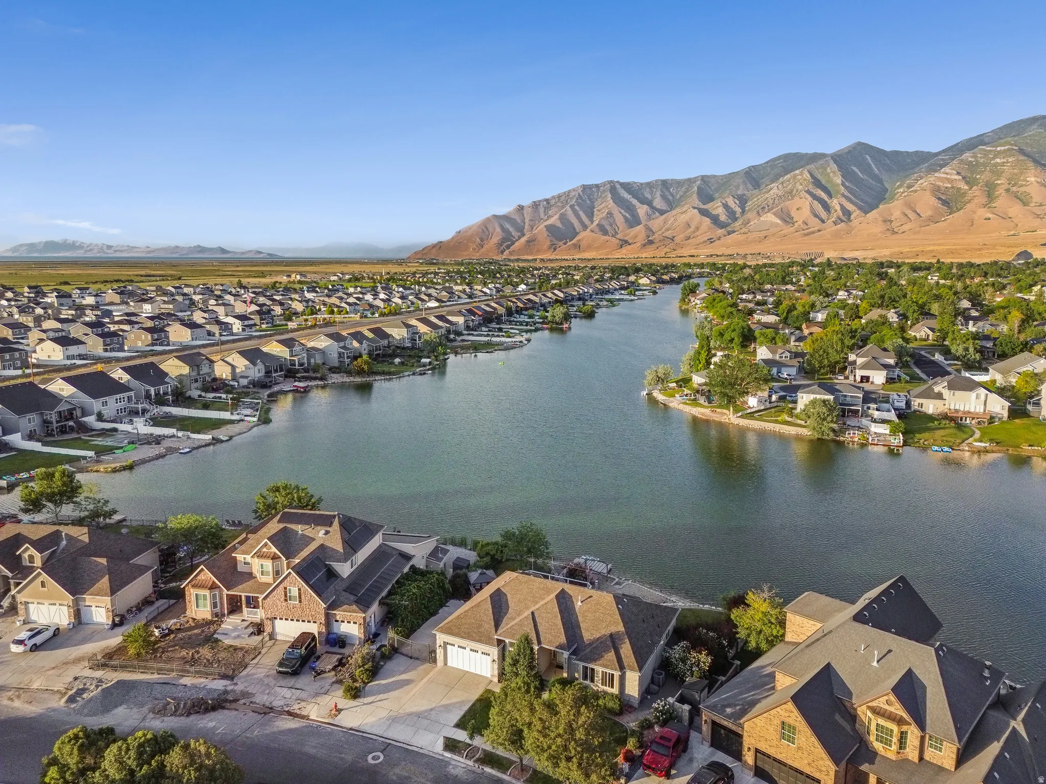 Aerial perspective highlighting a waterfront community with mountain and distant natural landscape backdrops