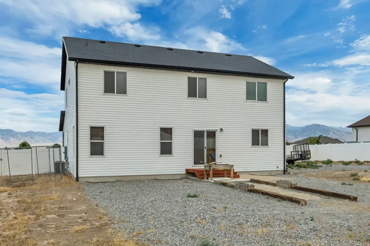 Two-story residence with white siding and a dark roofline