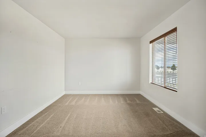 Neutral-toned carpeting paired with light-colored walls