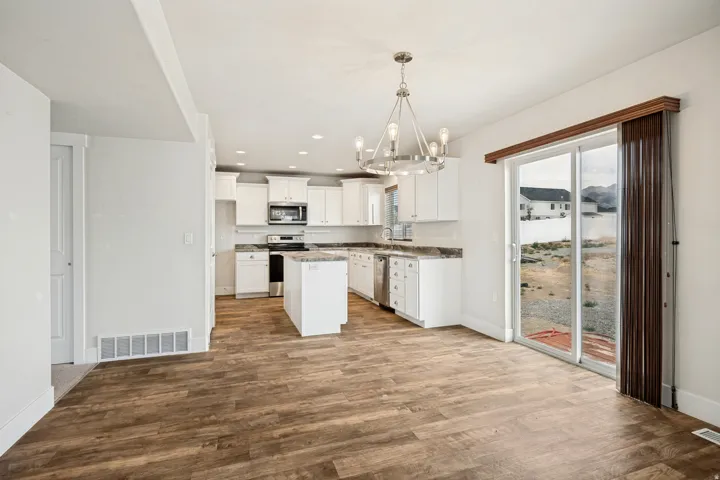 Spacious open-concept area featuring wood-finish flooring throughout