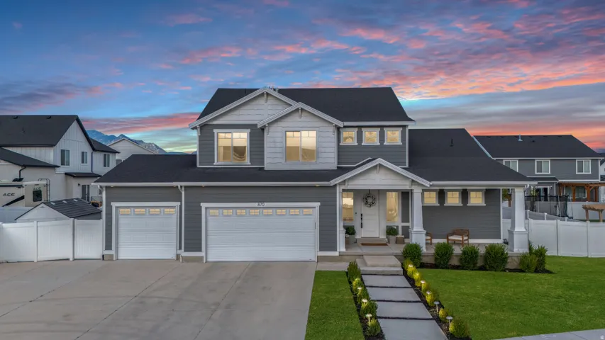 Modern two-story residence featuring a dark gray and light gray facade with white trim