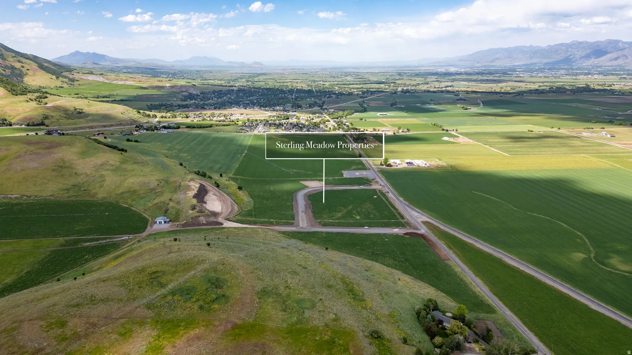 Expansive land parcel featuring existing road infrastructure and surrounding agricultural fields