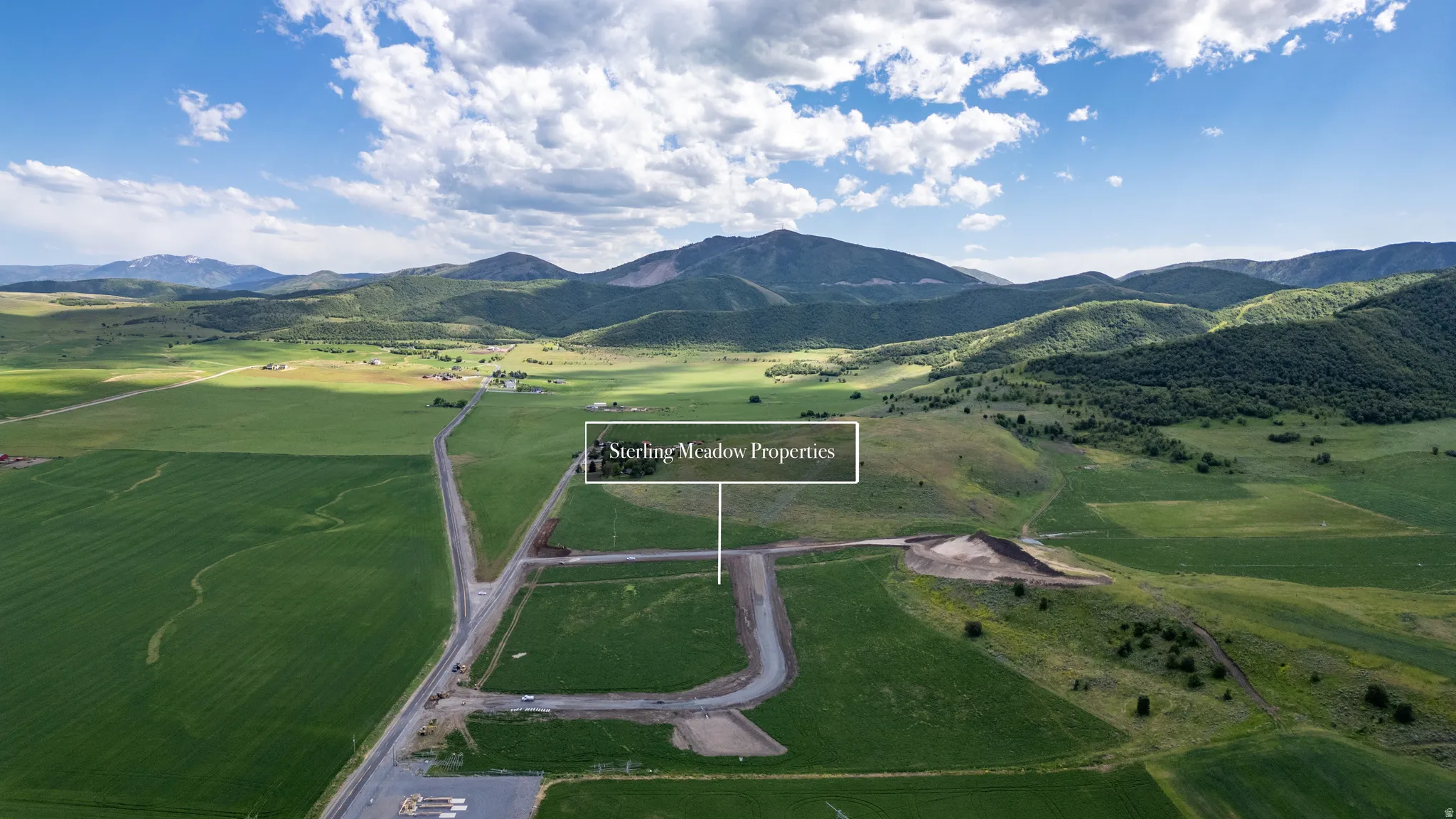 Expansive property featuring undeveloped land parcels and distant mountain ranges