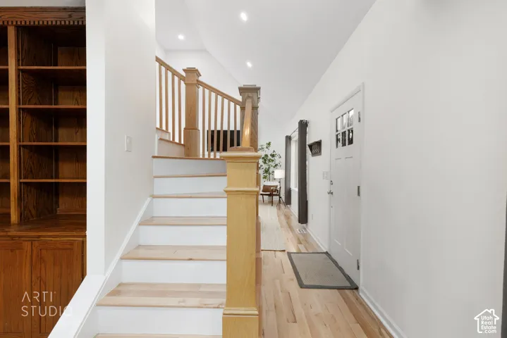 Hardwood flooring throughout the entry, staircase, and hallway