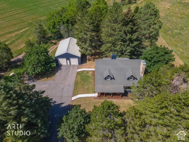 Aerial perspective showcasing a property surrounded by mature trees