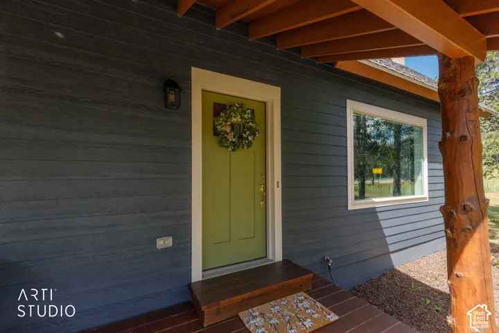 Charcoal-toned horizontal siding with a contrasting lime green entry door