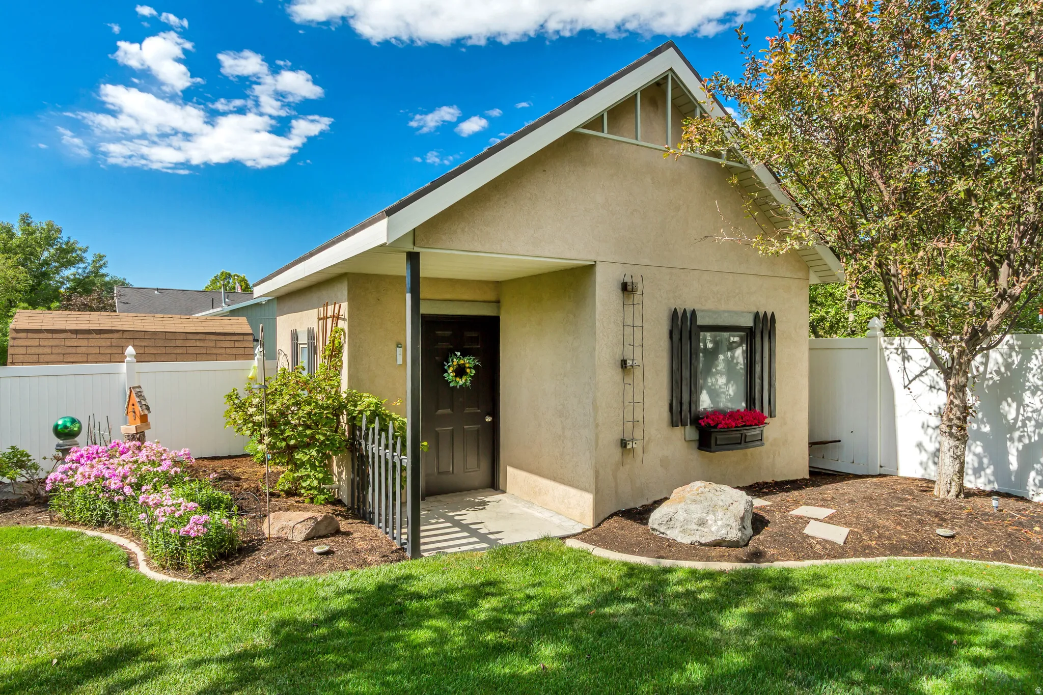 Stucco exterior with a pitched roof and covered entry