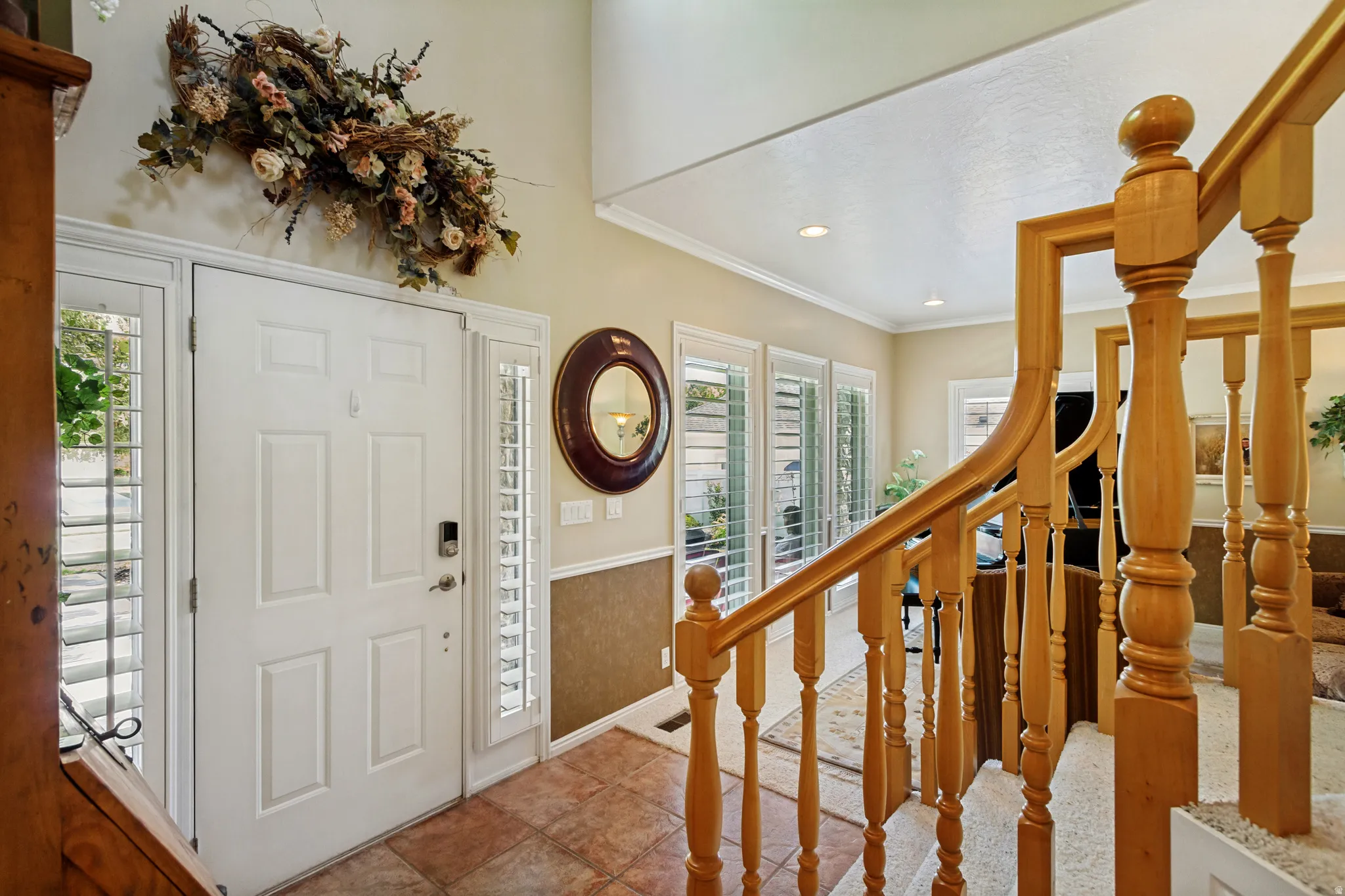 Entryway featuring a panel door with sidelights, transom window, and a smart lock