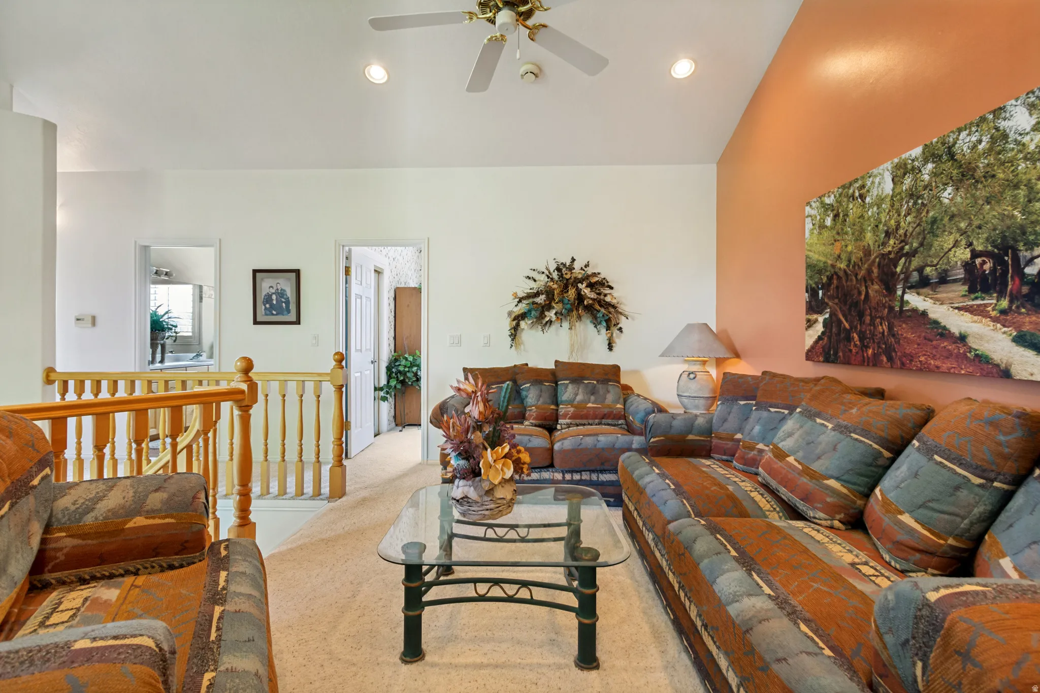 Open living area featuring vaulted ceilings, recessed lighting, and a ceiling fan