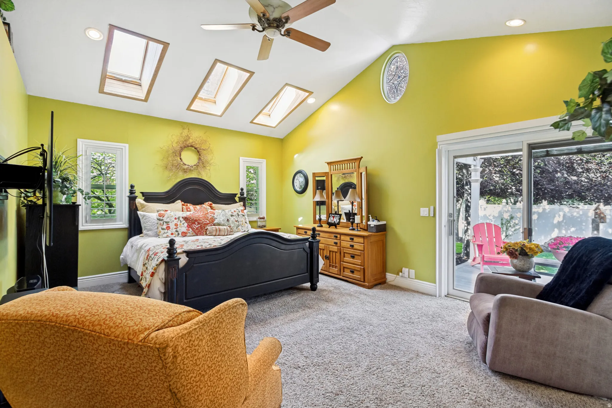 Vaulted ceiling with multiple skylights and a ceiling fan