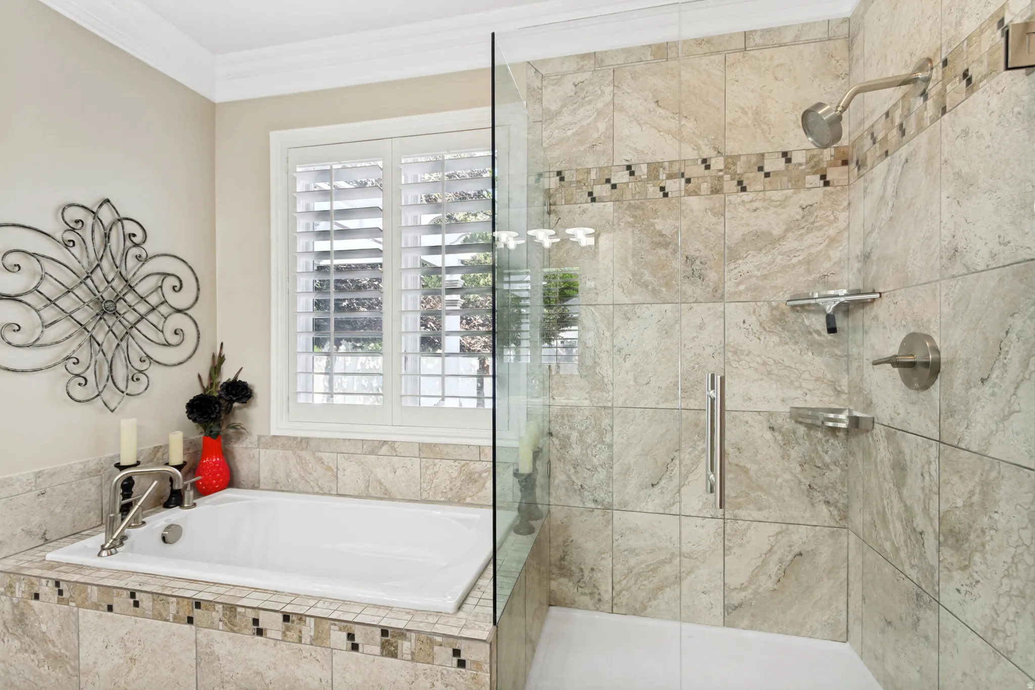 Built-in soaking tub with brushed nickel fixtures and surrounding tilework